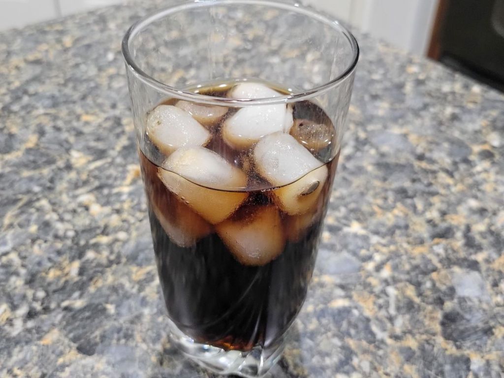 Bullet ice in a glass with soda