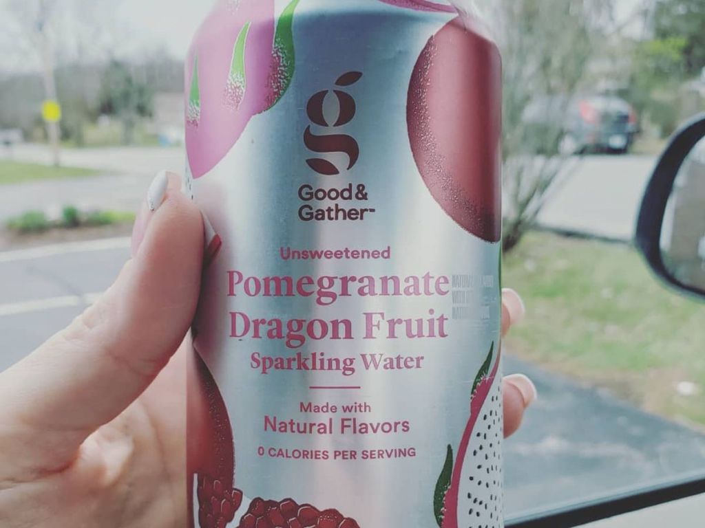 Hand holding a can of Good & Gather pomegranate dragon fruit sparkling water