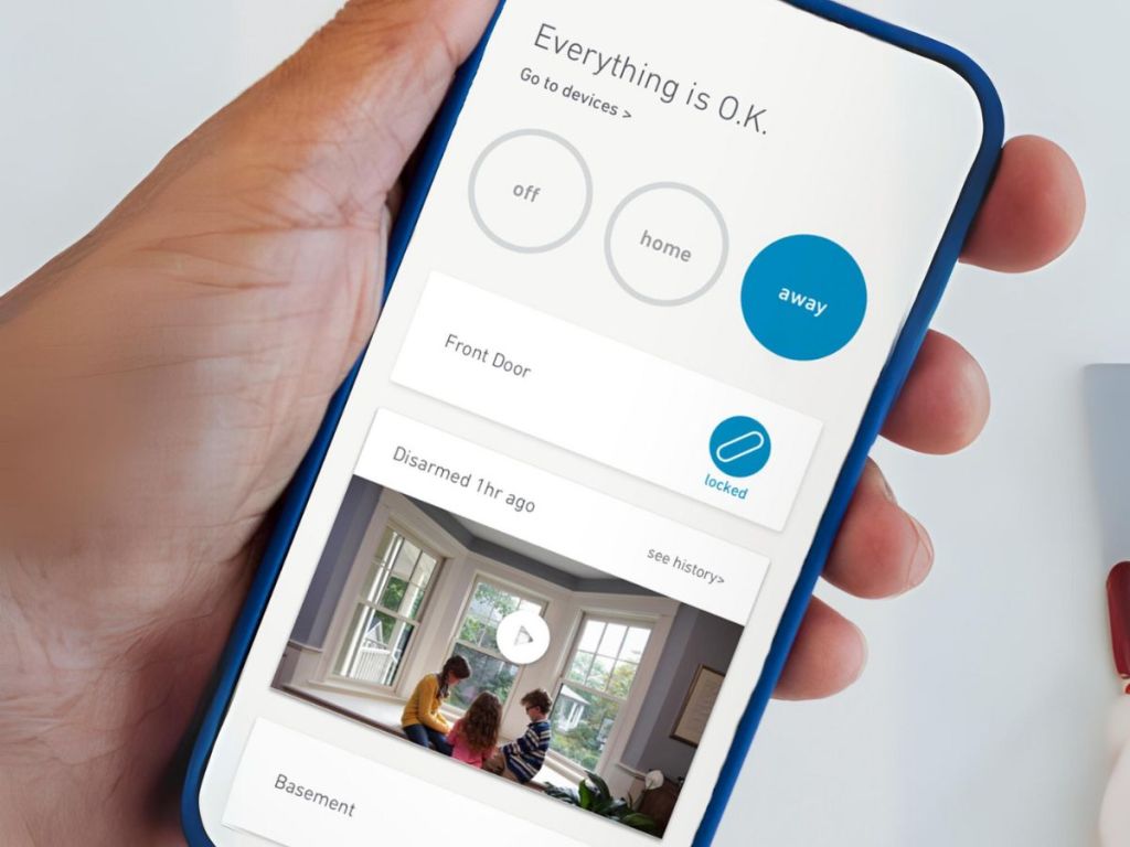 hand holding smartphone with the SimpliSafe app open looking at security system monitoring and video