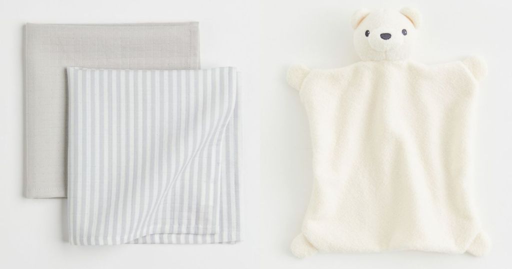 Two folded baby blankets and a plush bear 