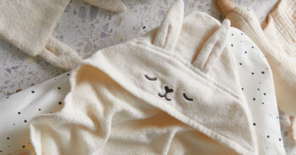 Hooded bath towel with a bunny face and bunny ears on it
