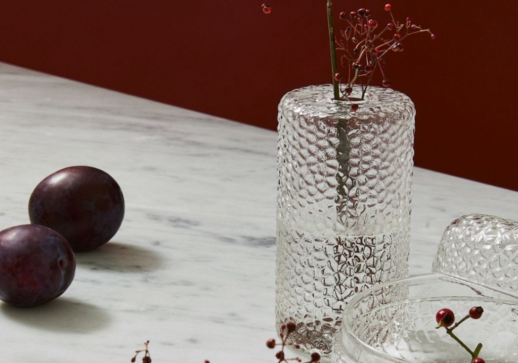 Tall glass vase with branches in it