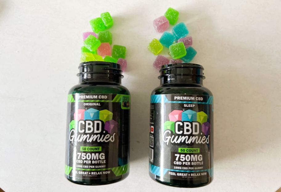 Two bottles of Hemp Bombs Gummies with some of the gummies spilling out of the top