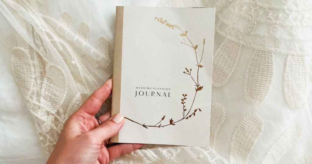 Minted Wedding Planning Journal shown in woman's hand
