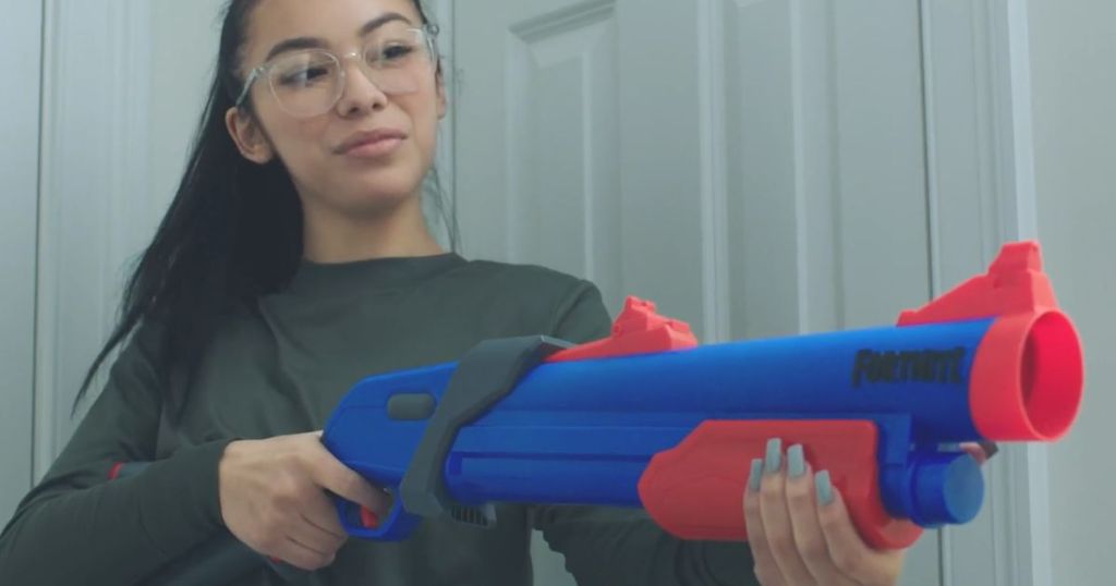 Teenage girl holding a Nerf Fortnite Pump Mega Dart SG Blaster
