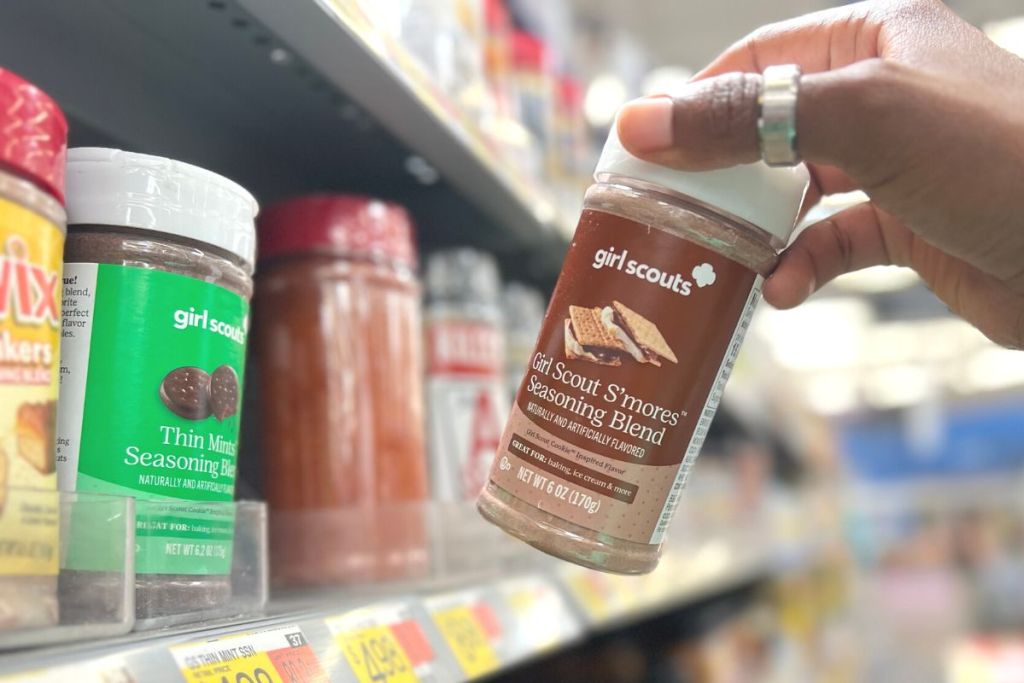 Girl Scout Seasoning Blend in woman's hand in store aisle with other seasoning shown