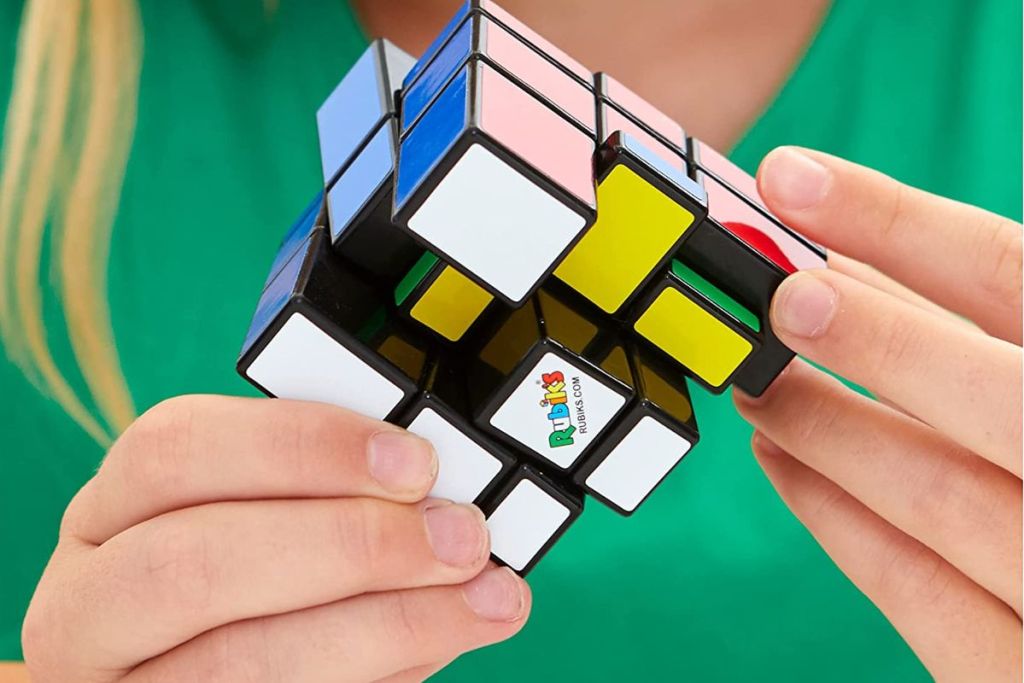 Girl holding a Rubki's Blocks 3x3 Puzzle Cube Game