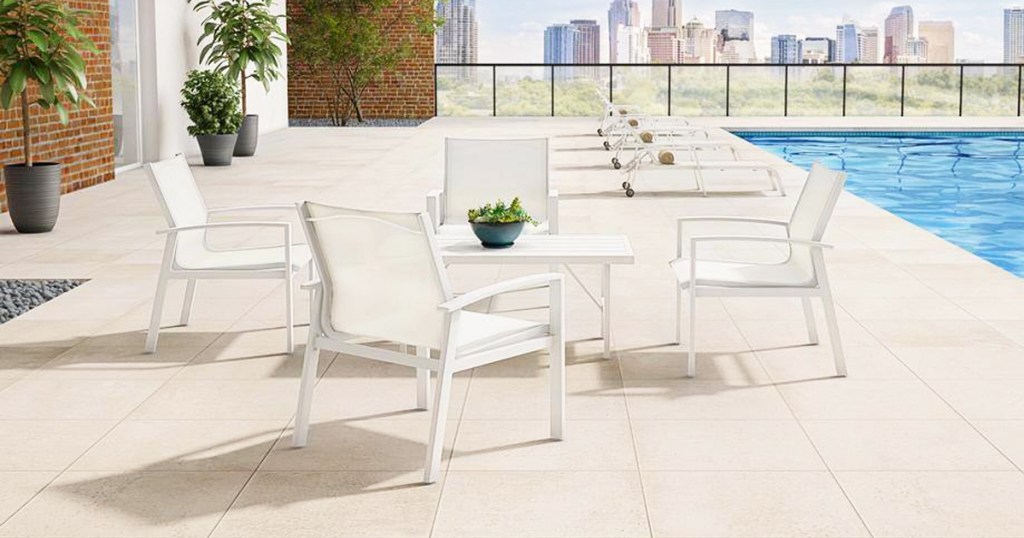 white metal table and chairs next to pool