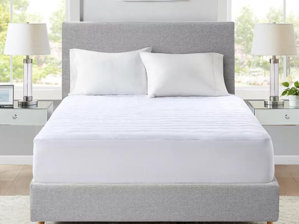 A bed with a Home Design Easy Care Waterproof Mattress Pads