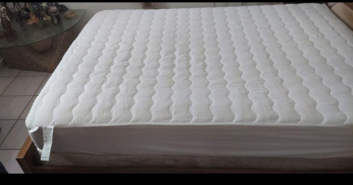 A bed with a Home Design Waterproof Mattress Pads