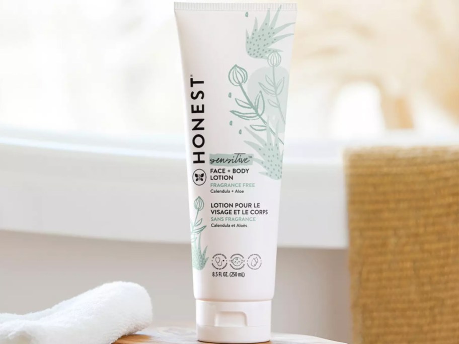 white tube of The Honest Company Lotion on a wood table