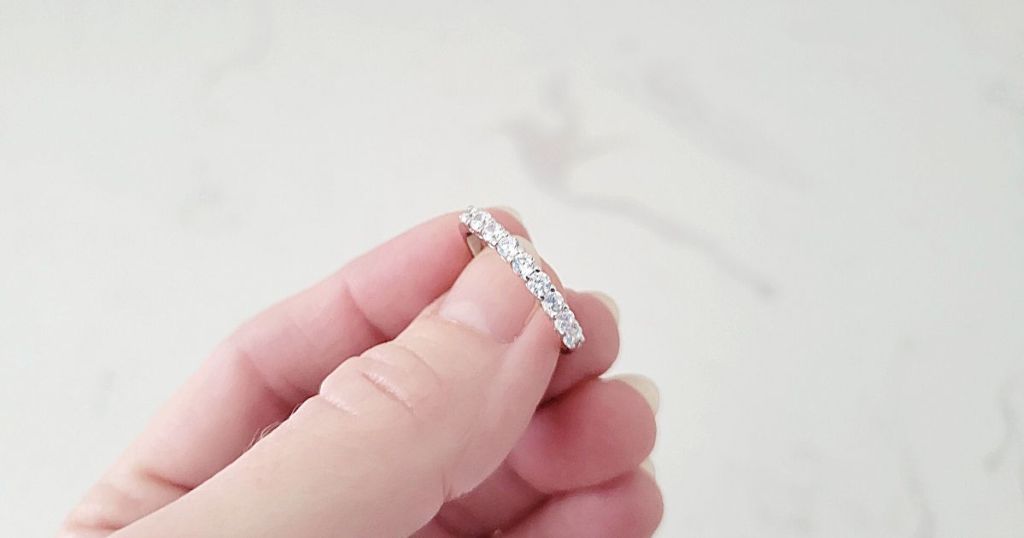 hand holding sparkly wedding band
