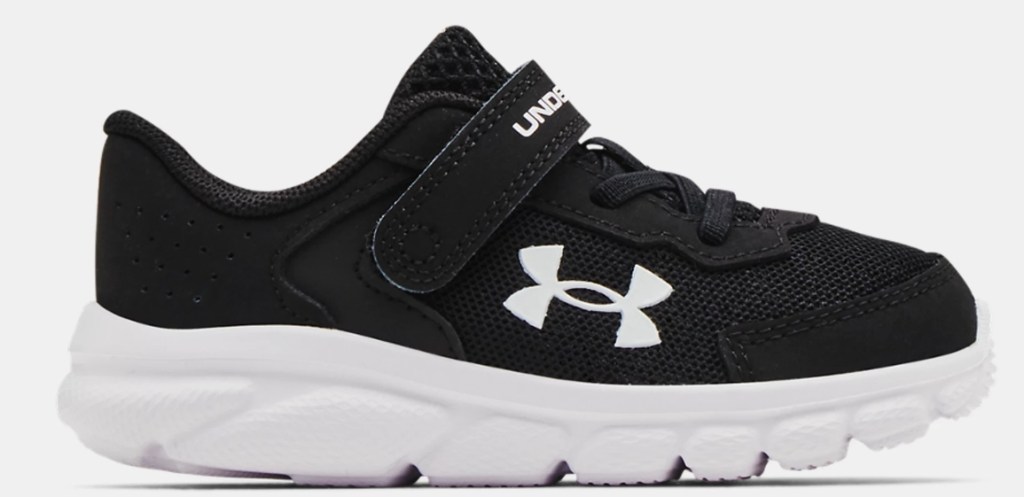 Black and white Under Armour kids running shoe