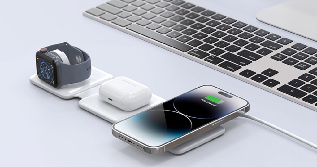 iphone, airpods, and apple watch all placed on a white charging station