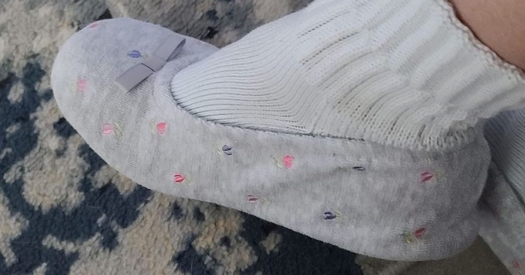 Foot with a sock and slipper on it