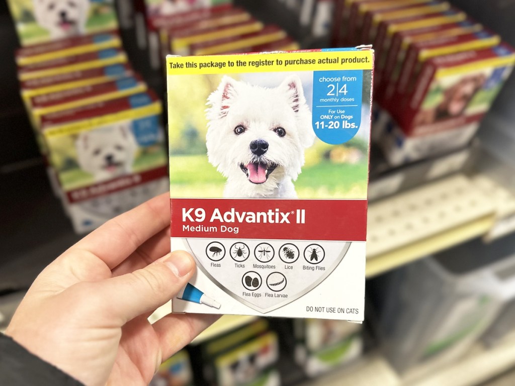 hand holding box of K9 Advantix II Dog Flea & Tick Treatment