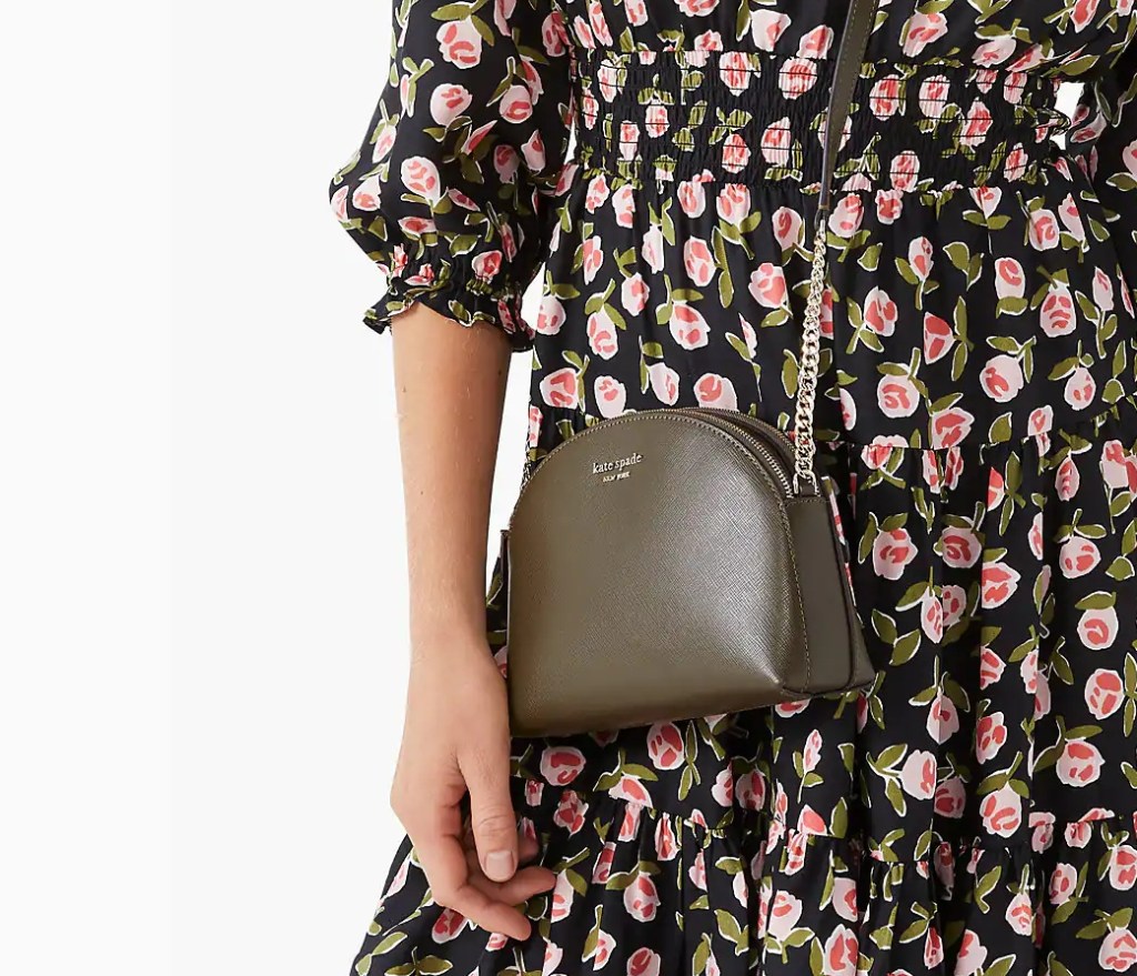 woman in a floral dress with a Kate Spade bag