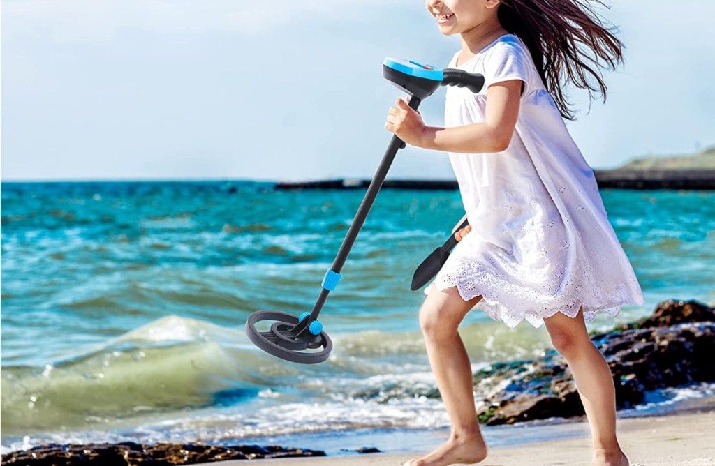 Girl running with metal detector