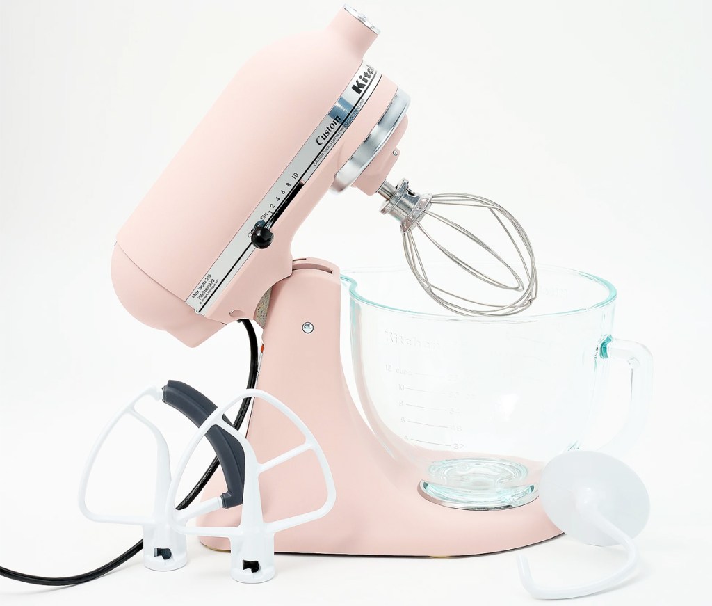 light pink kitchenaid mixer with glass bowl and attachments