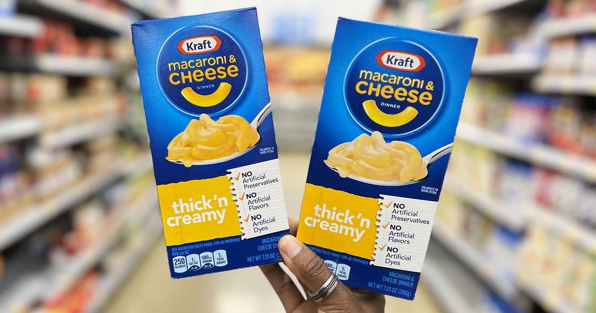 hand holding two boxes of Kraft Mac & Cheese