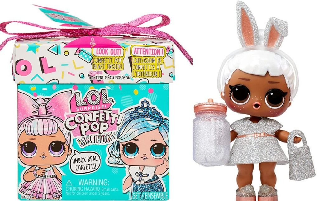 An LOL Surprise box with a Doll wearing bunny ears next to it with a bottle and purse.