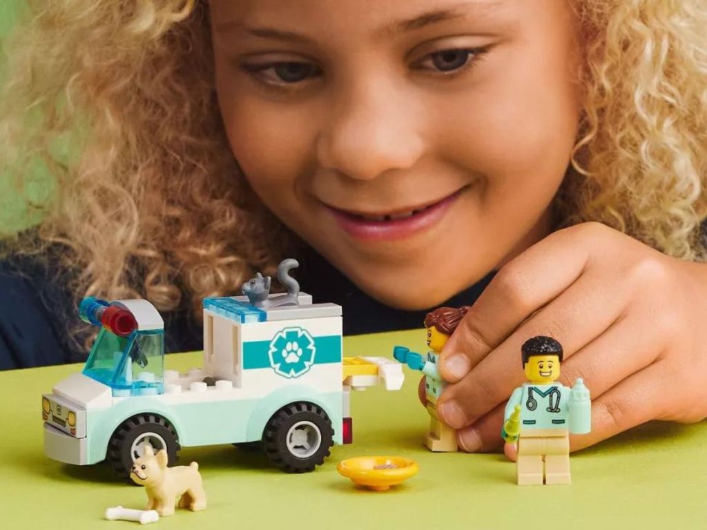 Little girl playing with the Lego Animal Vet Truck Set