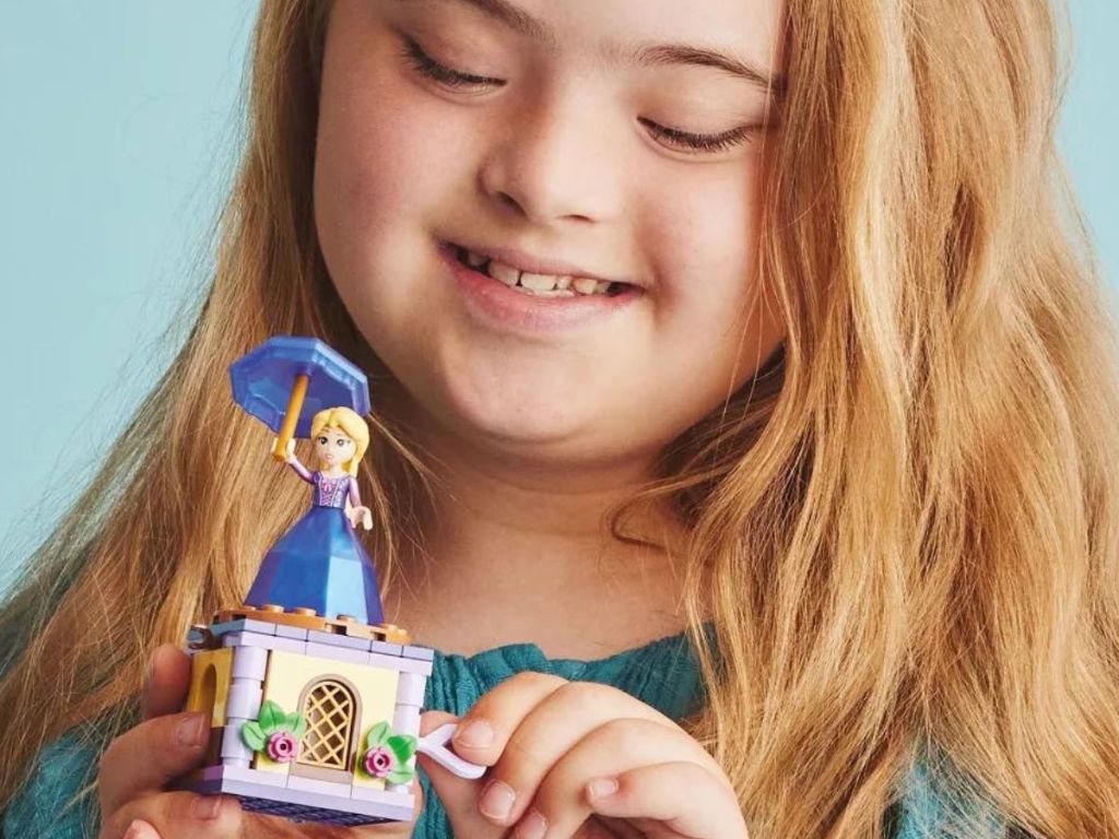 Little girl playing with Lego Disney Princess Twirling Rapunzel