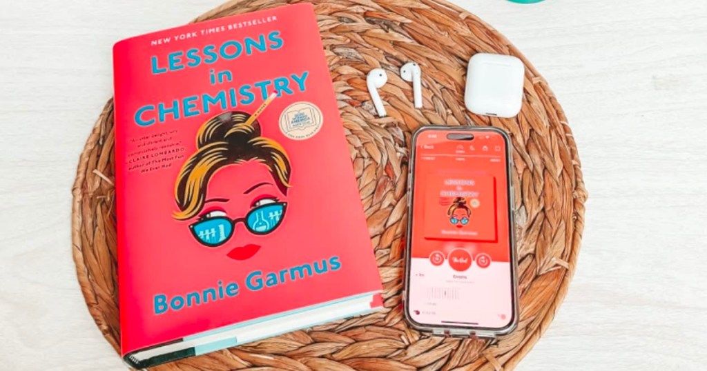 lessons in chemistry hardcover book and audio book on phone with headphones
