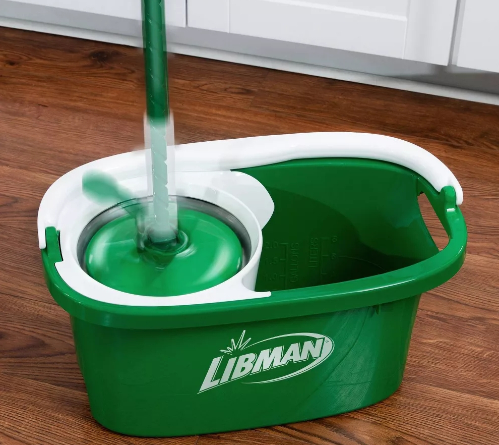 Green and white mop in a green and white mop bucket