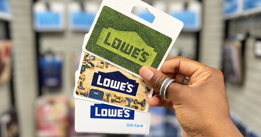 hand holding multiple lowes gift cards