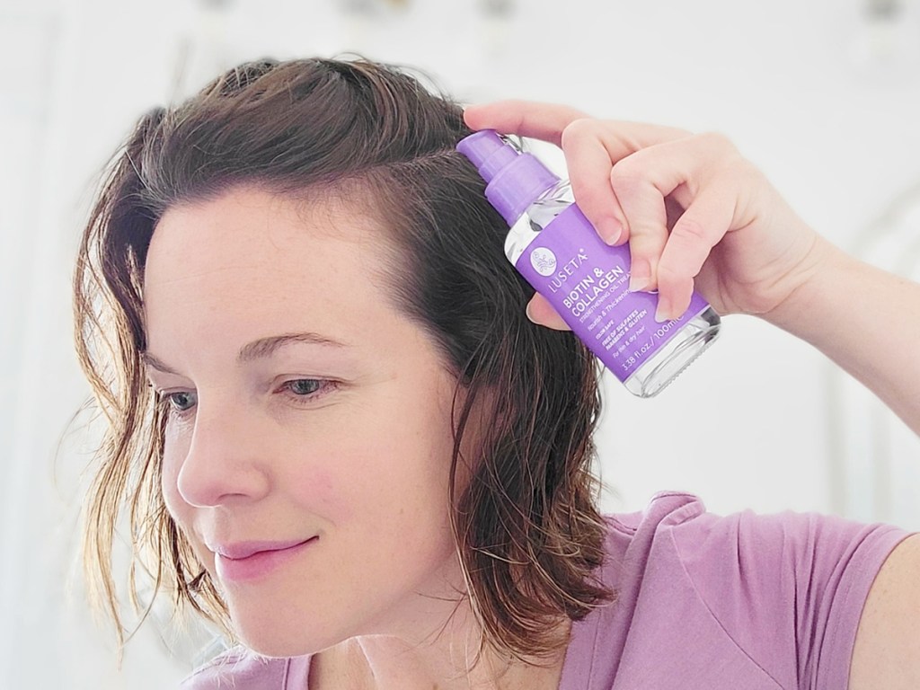 woman applying hair growth serum