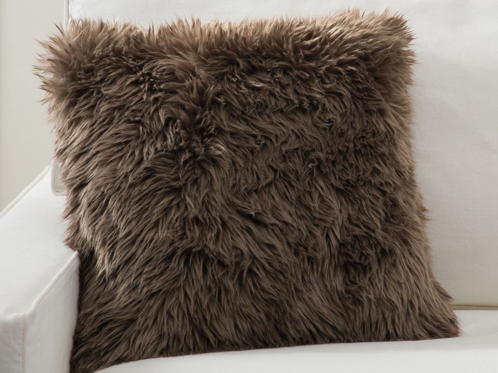 Luxe Faux Fur Pillow Cover in brown displayed on a couch