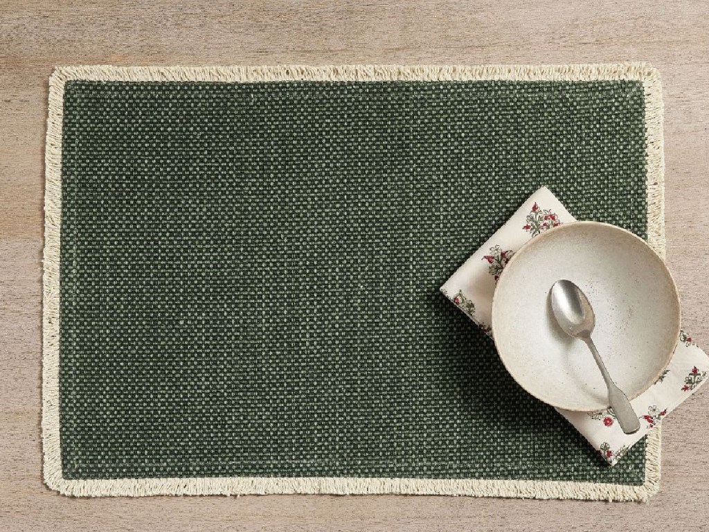 Mason Handwoven Cotton Fringe Placemats in green with bowl and napkin on table
