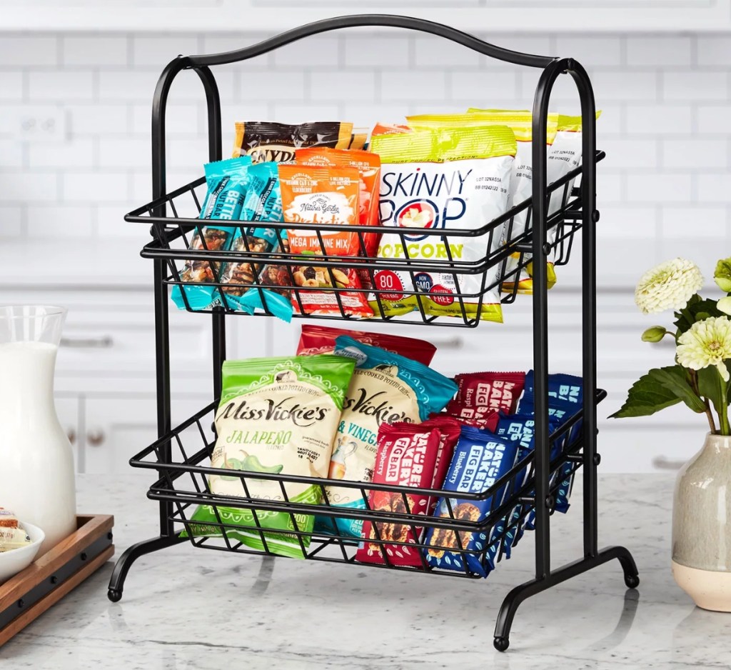 Two tier metal basket filled with snacks