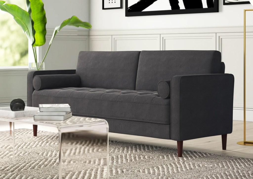 grey sofa in living room with clear coffee table