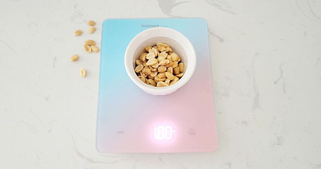 bowl of peanuts on blue and pink glass scale