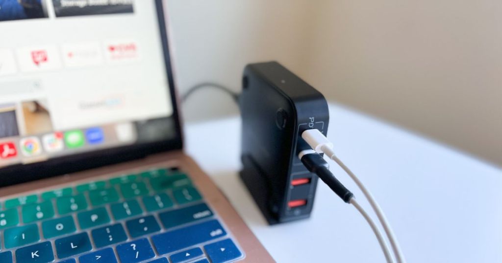 laptop and Momax USB C Charging Station with 2 cords hooked plugged into charger