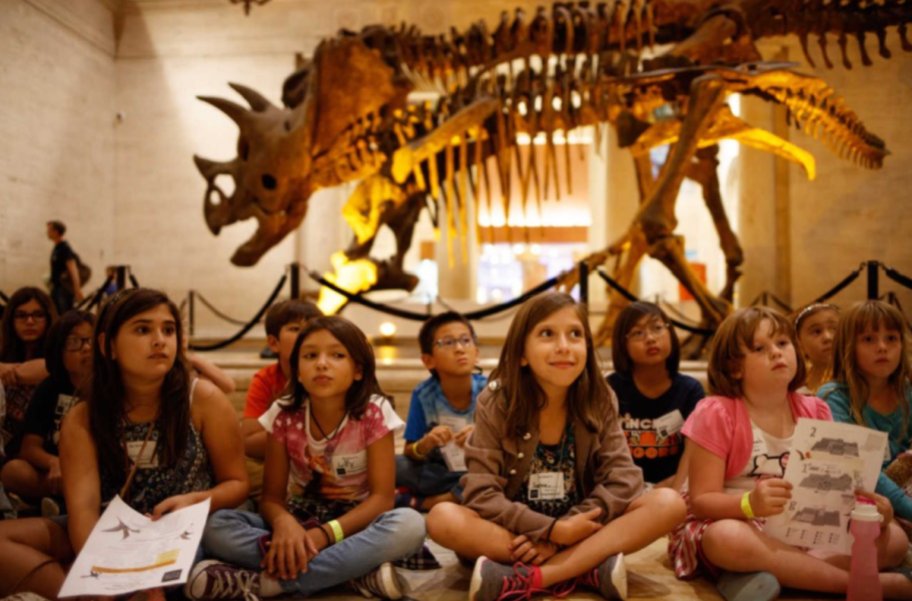 Children in the dinosaur exhibit at the Natural History Museum of Los Angeles County, one of the museums that give ebt card holders free or discounted admission