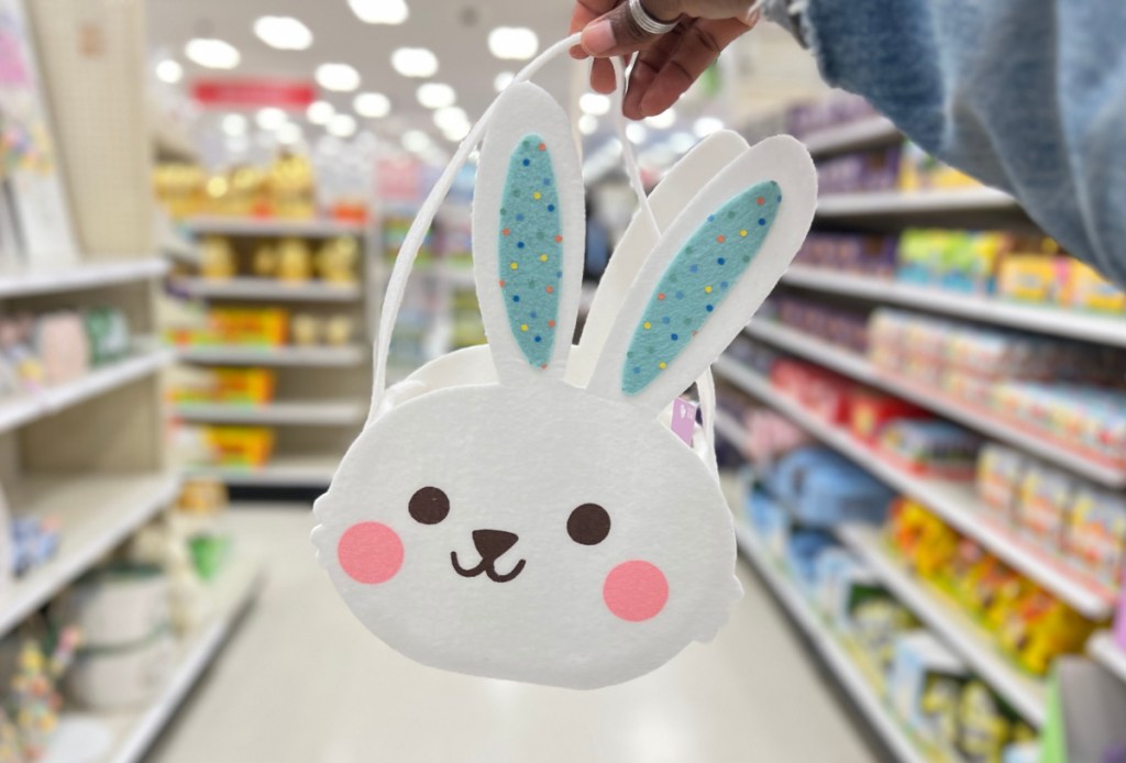 Woman holding up a felt Easter basket at Target