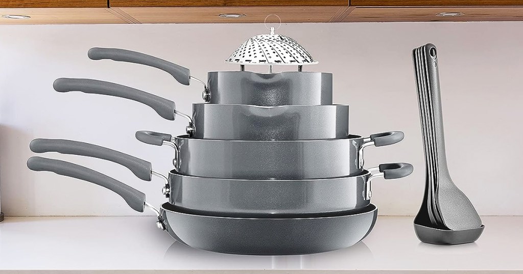 stacked set of grey cookware pieces and utensils on a kitchen counter