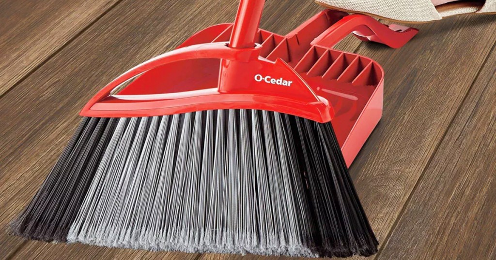 red broom and dustpan on wood floor