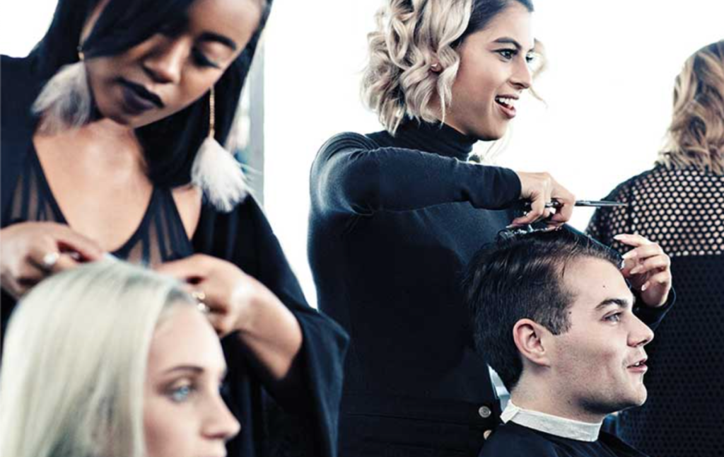 Stylists cutting hair at the Paul Mitchell Beauty School