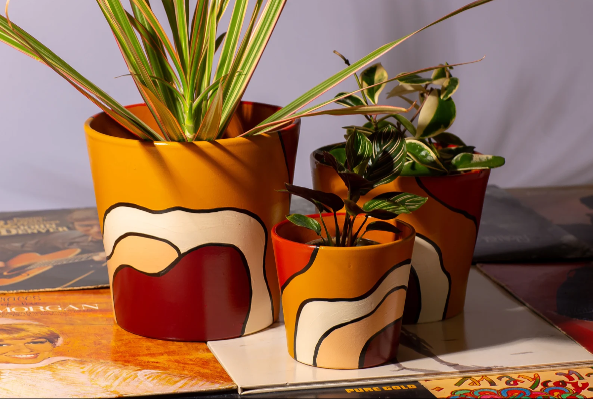 a trio of painted pots by PepperPalm, one of the top black owned etsy shops
