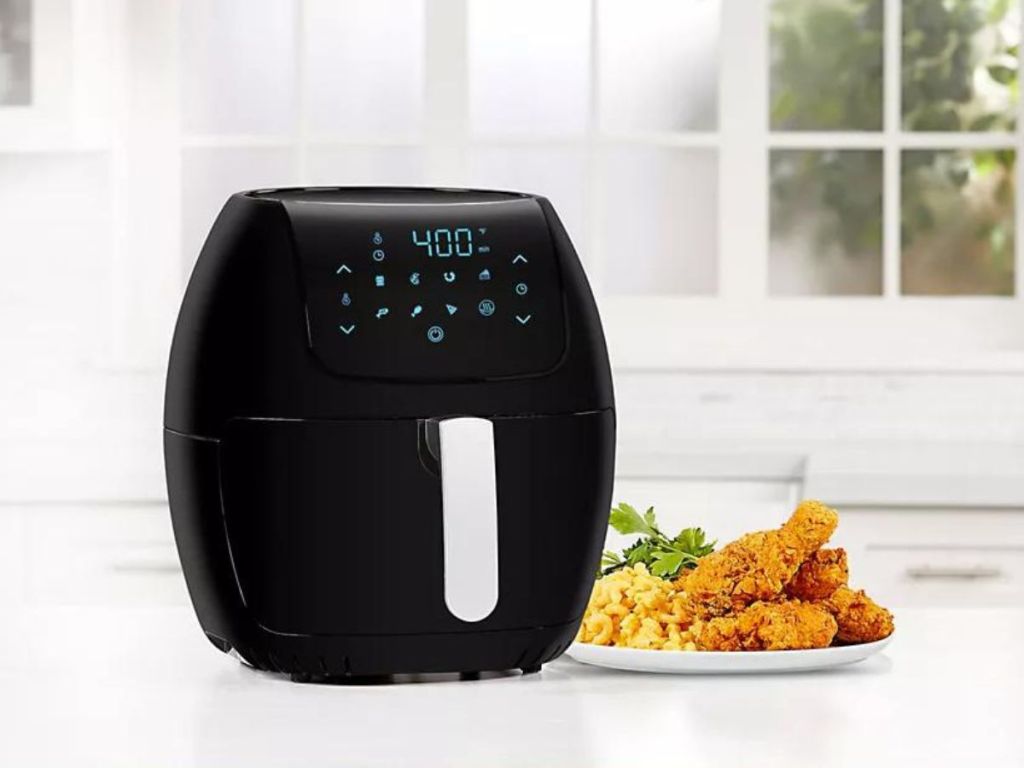 PowerXL 8-Quart Air Fryer with fried chicken and mac n cheese on plate next to air fryer