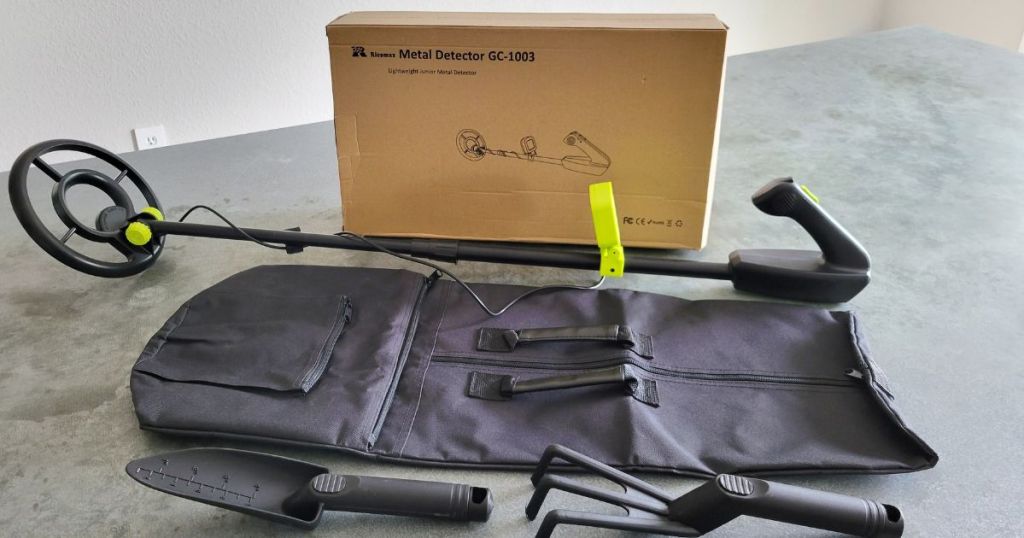 metal detector, packaging, storage bag, and two shovels