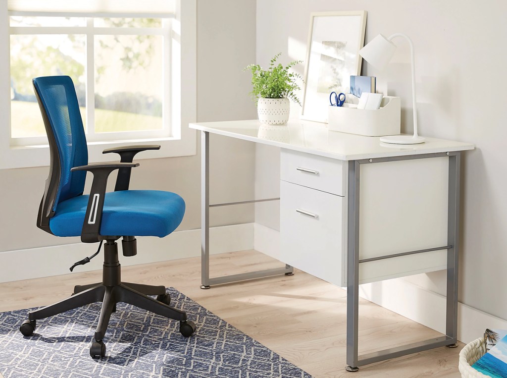 blue office chair next to a white and silver desk