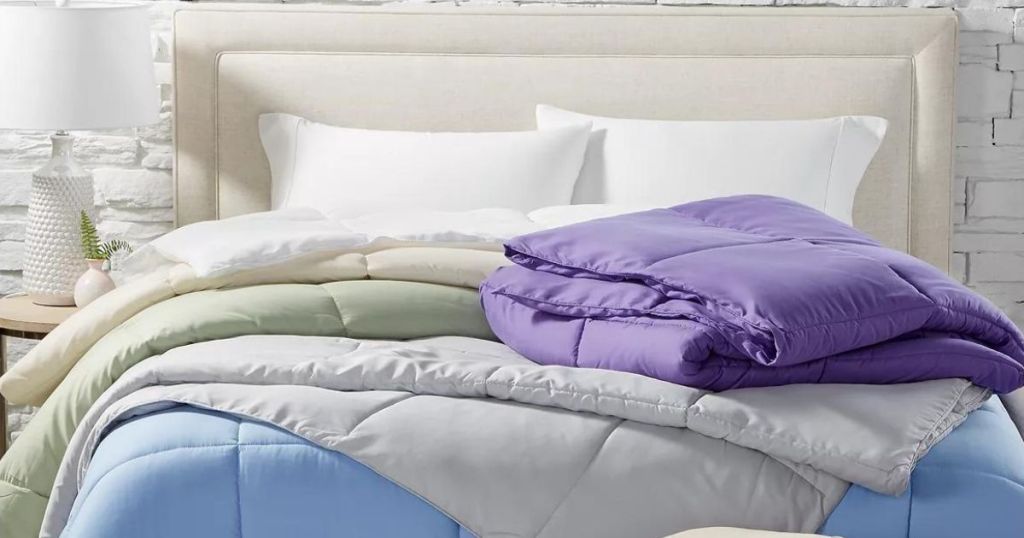 layers of colorful comforters on bed