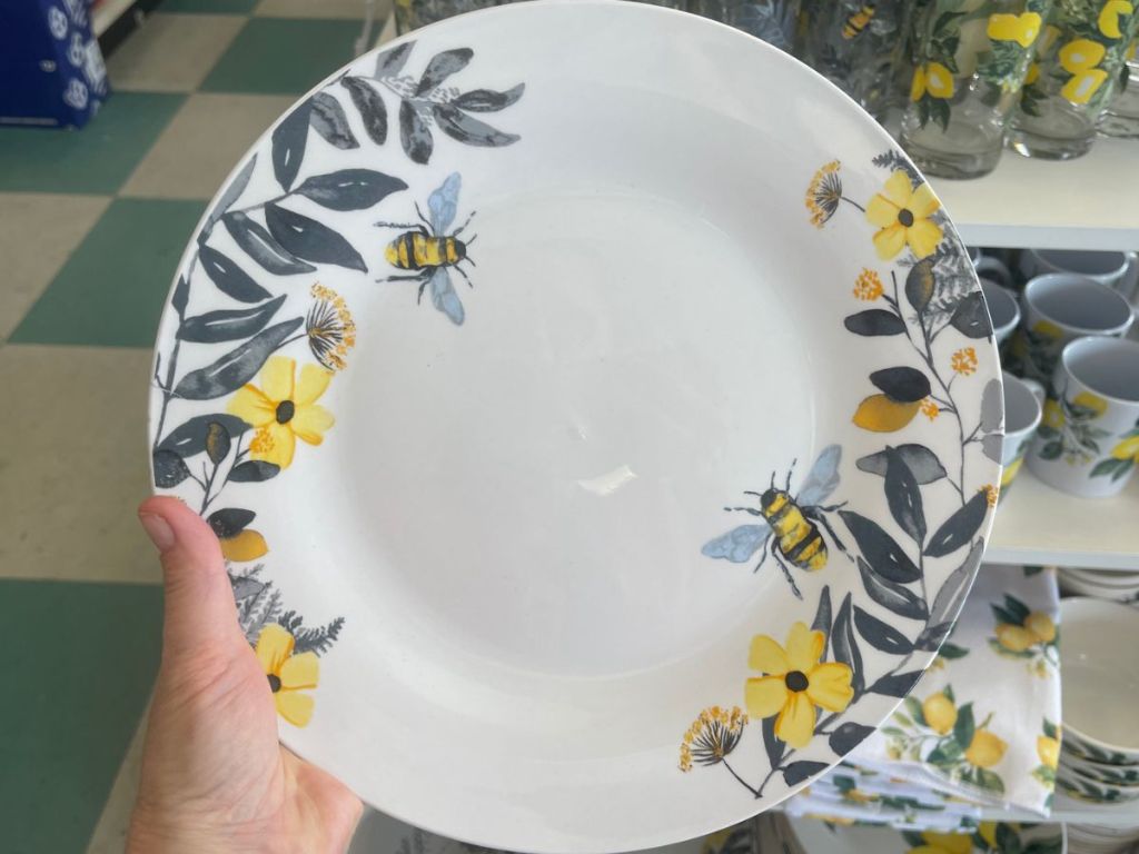 A plate with bees and yellow flowers on it. 