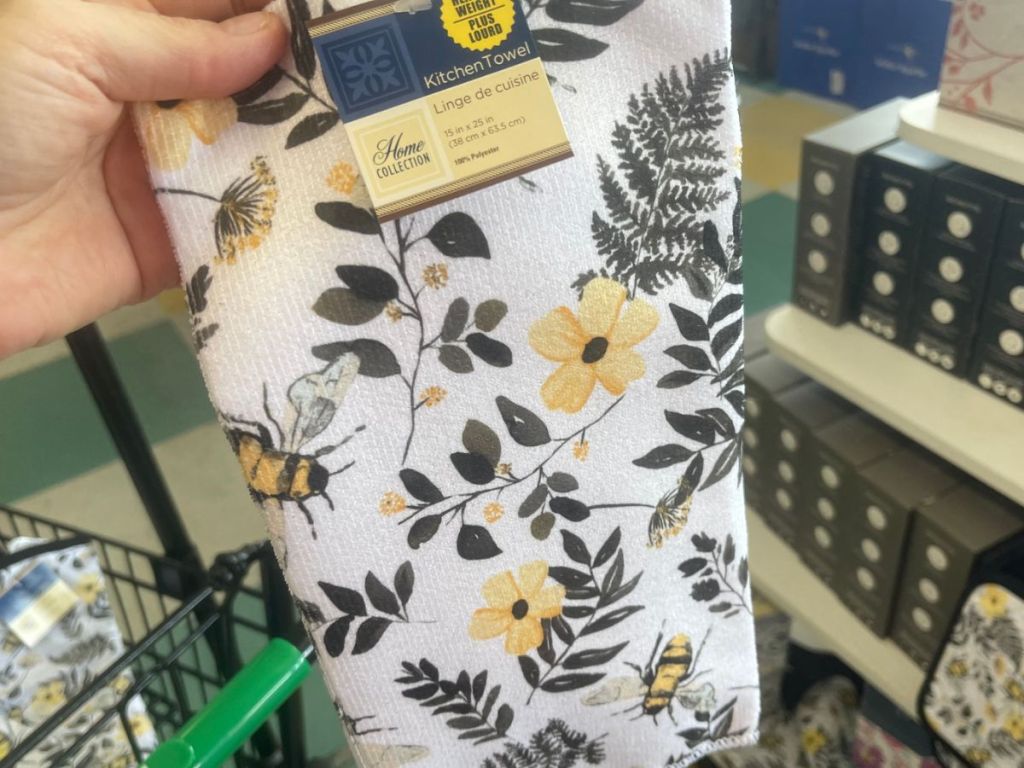 A tea towel with bees and yellow flowers o