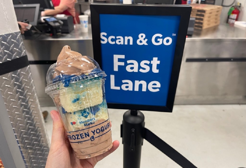 Hand holding up a frozen yogurt bought with the Scan & Go app at the Sam's Club food court